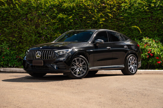 Black Mercedes-Benz GLC 43 AMG front three quarter view, Sport SUV coupe in nature