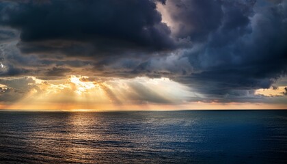 Fototapeta premium Sunlight Breaking Through Dark Storm Clouds With Dramatic Rays Over Ocean Horizon