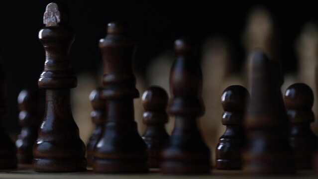 Animated sequence showing chess pieces on revolving board, capturing the essence of strategic decision-making and the black versus white dichotomy in chess