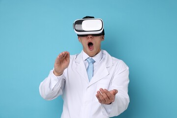 Modern technology. Doctor using virtual reality headset on light blue background