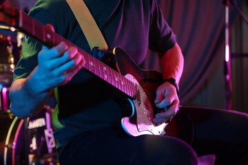 Naklejka premium Man playing electric guitar on stage, closeup