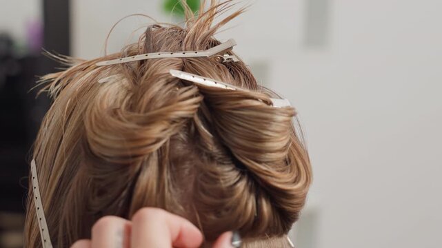 Professional bridal hairdo featuring ornamental pins and artistic styling, Chic and refined wedding hair arrangement enhanced by decorative accessories and expert styling techniques