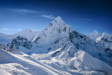 Obraz premium Aerial view of the snowy mount Ama Dablam. Helicopter flight over Himalaya mountains in Khumbu region, Nepal.
