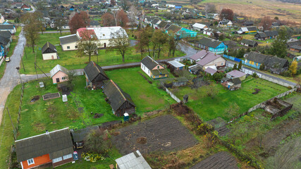 Aerial view of Belarus village with barns, cottages, and plots