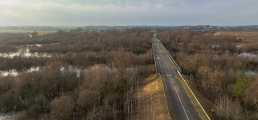 Aerial bridge over flooded leafless forest and wetlands in Belarus