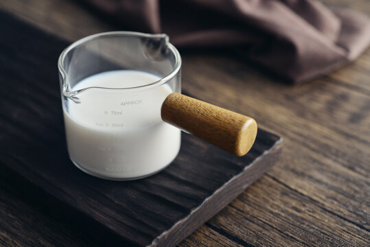 Milk in measuring glass cup