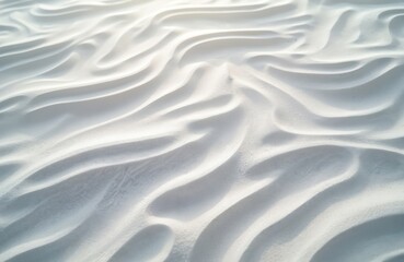 Obraz premium Close up abstract view of fine white sand dunes with flowing wave patterns. Soft light creates gentle shadows accentuating natural organic shapes, ideal for calm backgrounds.