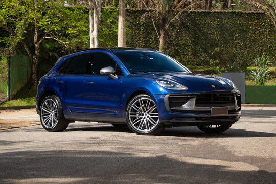 Blue Porsche Macan T front three quarter view, Stylish SUV on sunny day