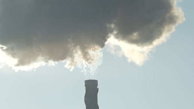 Smoke Rising from Industrial Chimney. Conceptual pollution and climate change imagery.