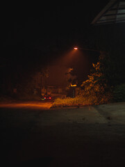 Fototapeta premium Empty Night Road With Warm Street Light Glow