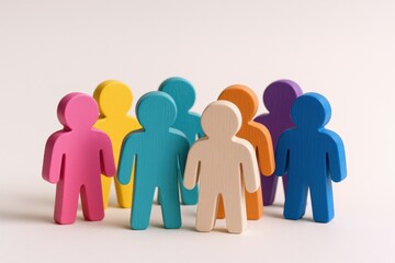 Diverse group of colorful wooden figures representing teamwork, inclusion, community, and collaboration on a white background