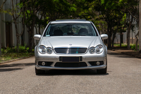 Silver Mercedes-Benz C55 AMG front view straight on, Classic German sports sedan outdoor