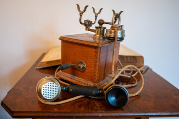 Communication progress, old wooden French rotary dial telephone and phone numbers catalog book from Paris, 1937