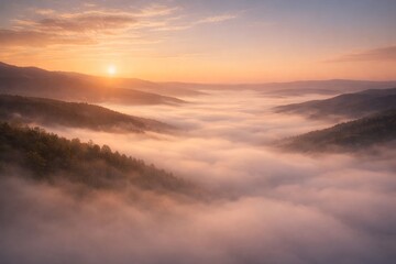 Obraz premium Minimal cinematic landscape of a foggy valley at sunrise, with soft golden light and layered mountains creating a calm atmosphere and large copy space for commercial use.