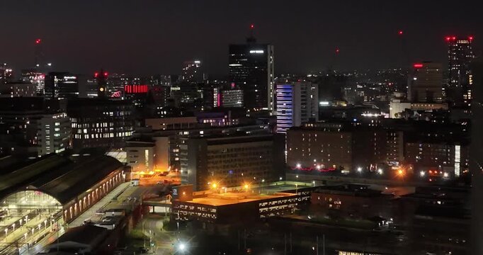 Aerial views of the bright lights of downtown Manchester at dusk