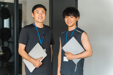 Sports gym, trainer in training gym, male instructor staff