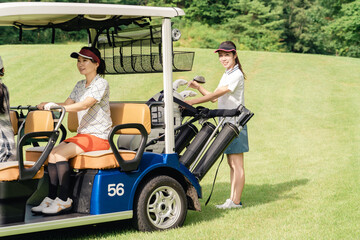 Female golfer riding a golf cart at a golf course (golf girl)