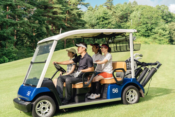 Male and female golfers riding golf carts at a golf course