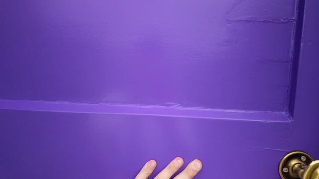 Person opens purple door after walking through lavender field