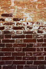 Fototapeta premium Aged Brick Wall Texture Highlighting Rustic Urban Patina Surface in Natural Light Reflected Exposed Brick Architecture, Vertical Shot