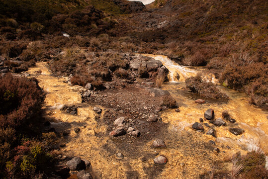 Silica Rapid terraces on the slopes of volcanic Mount Ruapehu, Tongariro National Park New Zealand. Creamy white aluminium and silicate minerals dissolved in the water are deposited on the stream bed.