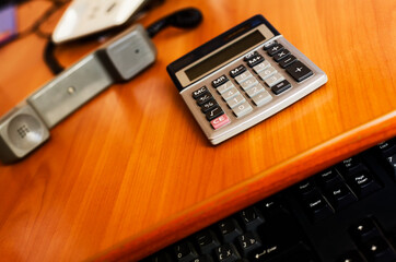 Office Workspace: Desk with Calculator, Telephone, and Keyboard in Efficient Business Setup