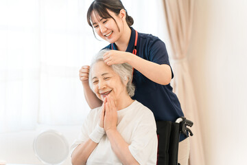 Fototapeta premium Senior women receiving hair styling at nursing home, nursing beauty salon