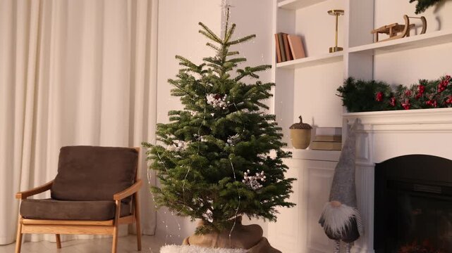 Beautiful Christmas tree and decorative gnome near fireplace at home