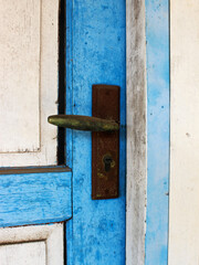 Close-up view of an old door knob of wooden door. 