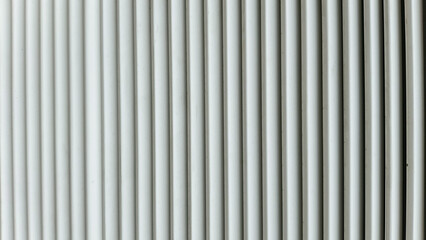 Minimalist background of white vertical parallel lines with subtle shadows. Clean architectural geometric texture