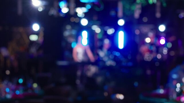 Colorful lights and lively crowd, Blurry dance floor with bright colors and pulsing sound setup