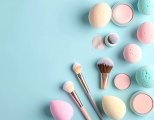 Makeup arrangement on blue, featuring sponges, brushes, and powders