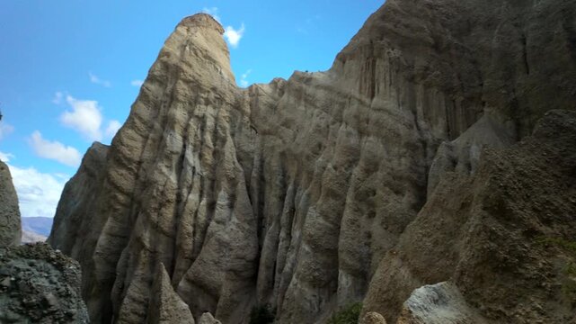 Towering Clay Cliffs pinnacles against blue sky in New Zealand