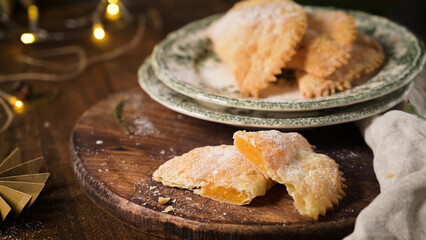 Sweet Fried Pastries with Orange Jam Filling on Rustic Wooden Platter