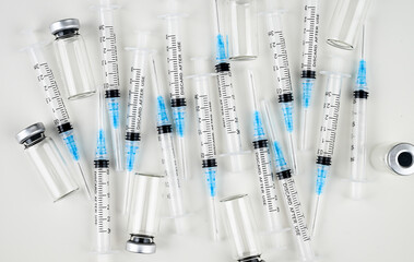 Single Use Syringes with Needles on White Background