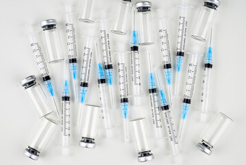 Single Use Syringes with Needles on White Background