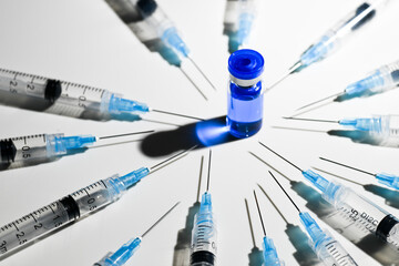Single Use Syringes With Needles and Vial With Copper Peptides on White Background