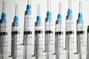 Single Use Syringes with Needles on White Background