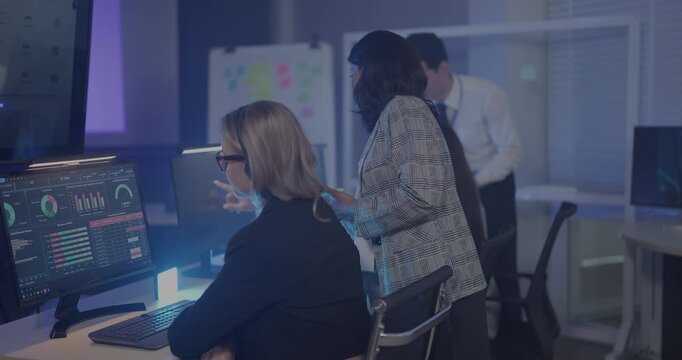 A focused team wearing headsets monitors live analytics dashboards and collaborates in modern control room. Highlighting customer support, data driven decision making, coordinated incident response.
