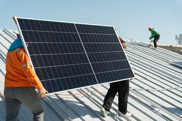 Workers install solar panels on a rooftop in a sunny location during daytime in an effort to promote renewable energy sources