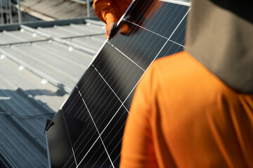 Workers install solar panels on a rooftop in an urban setting during daylight hours