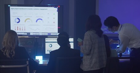 A focused team wearing headsets monitors live analytics dashboards and collaborates in modern control room. Highlighting customer support, data driven decision making, coordinated incident response.
 - Powered by Adobe
