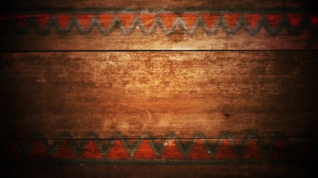 Old brown wood board with red triangle pattern on top and bottom in dark room video