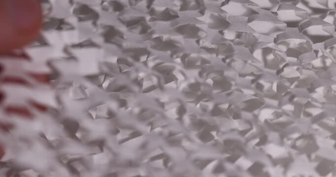 white paper with a lot of cuts is used for packaging and decorative purposes, white paper with cuts and a lot of holes is used for packaging goods and other purposes