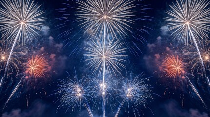 Spectacular blue and orange fireworks display exploding in the dark night sky during a festive New Year celebration event