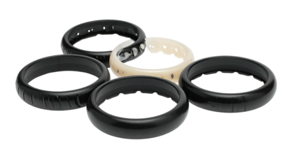 Five rings, primarily black, some with texture, isolated on a dark background