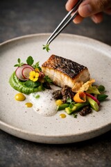 Fine dining plate with seared fish, pea puree, morels, and colorful vegetables as a chef adds herbs with tweezers, perfect for restaurant branding and culinary editorials.