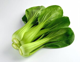 Fresh, vibrant bok choy heads on a white surface, top view