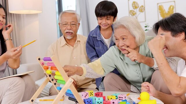 Asian Family Enjoys Educational Toy Game Together at Home