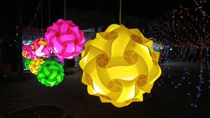 Illuminating Sphere of Color: A mesmerizing collection of vibrant, spherical lights hangs, casting a warm glow, creating an atmosphere of festive celebration.